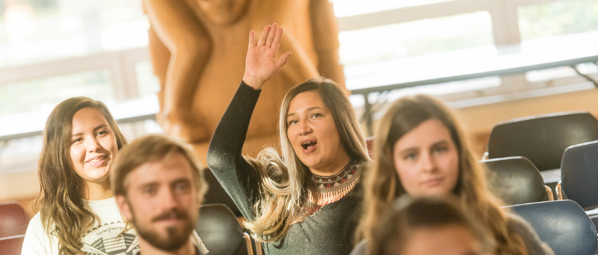 Woman raising her hand in the First Nations Longhouse